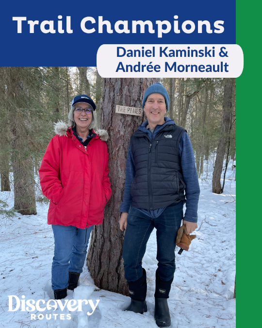 man and woman leaning against a tree in a winter forest