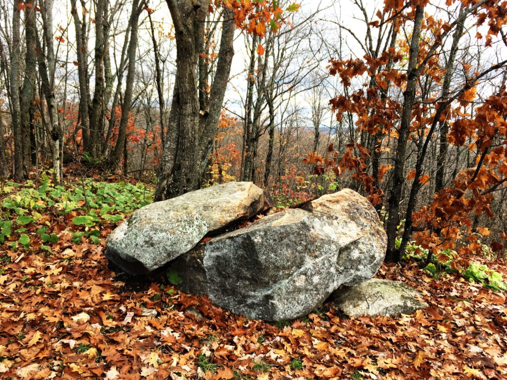 Glacial erratic rock on Tower Trail hiking trail in fall