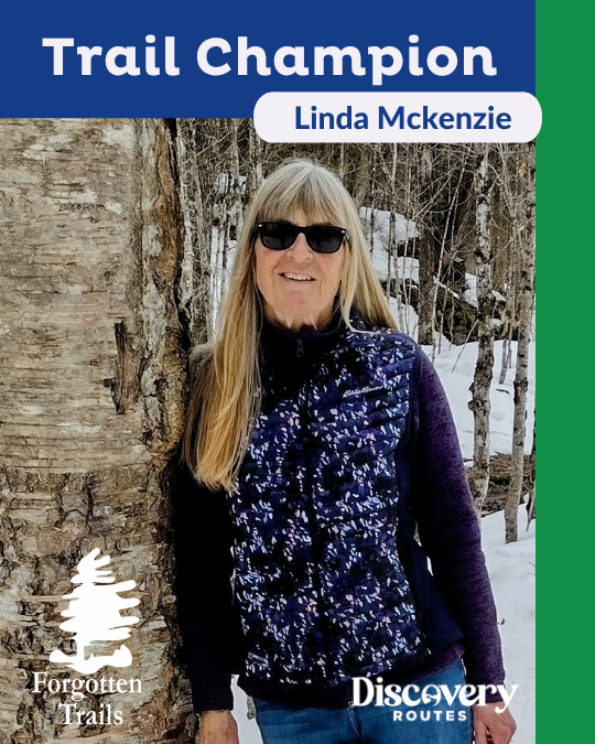 woman leaning against a tree in the winter with sunglasses